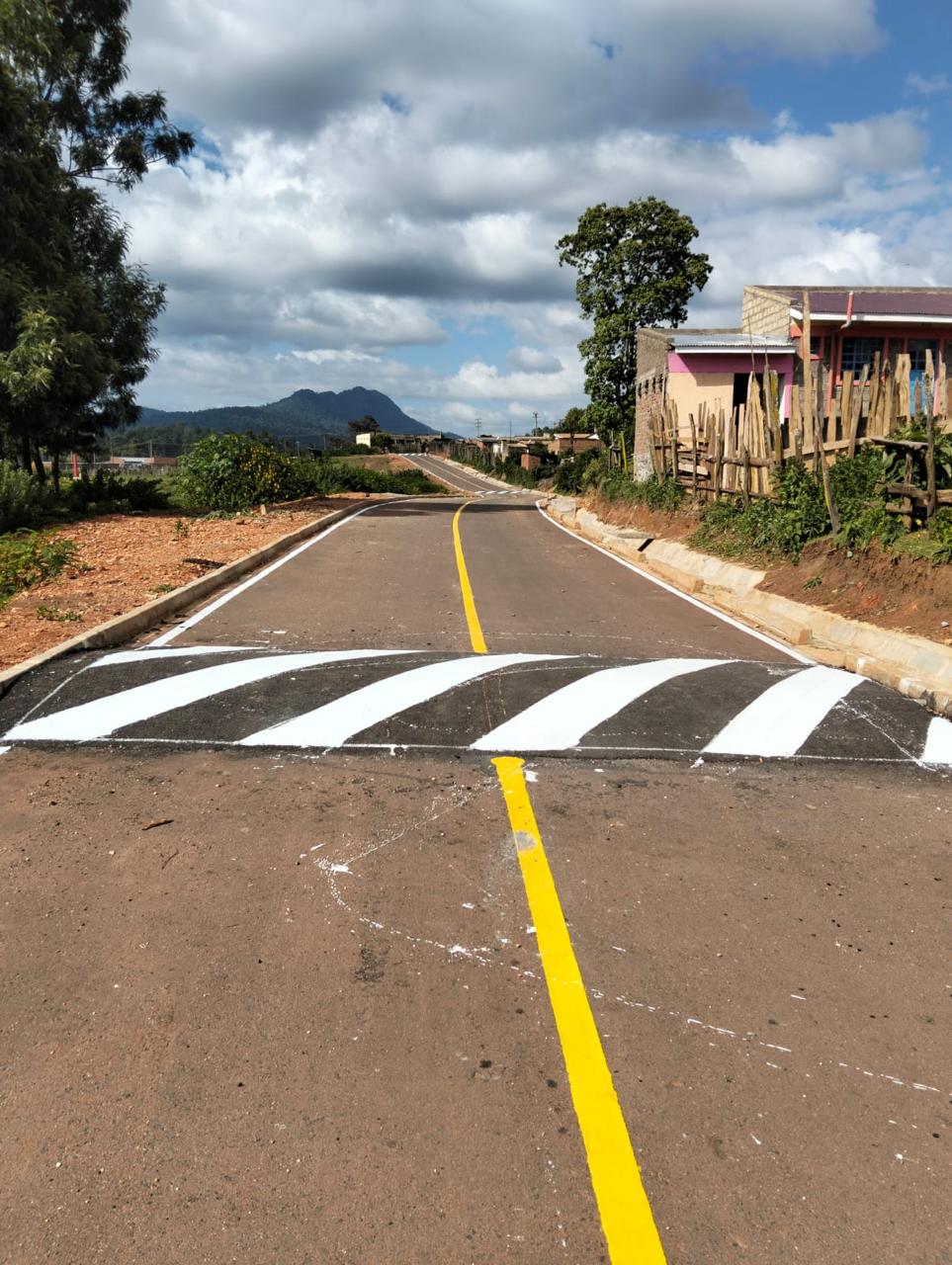 Completed road with speed-calming hump and line markings